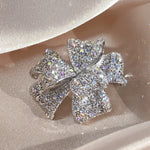 Load image into Gallery viewer, SO SEOUL Graceful Ribbon Bow 3D Layered Oversized Aurore Boreale Crystal Rollover Clasp Brooch
