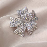 Load image into Gallery viewer, SO SEOUL Graceful Ribbon Bow 3D Layered Oversized Aurore Boreale Crystal Rollover Clasp Brooch
